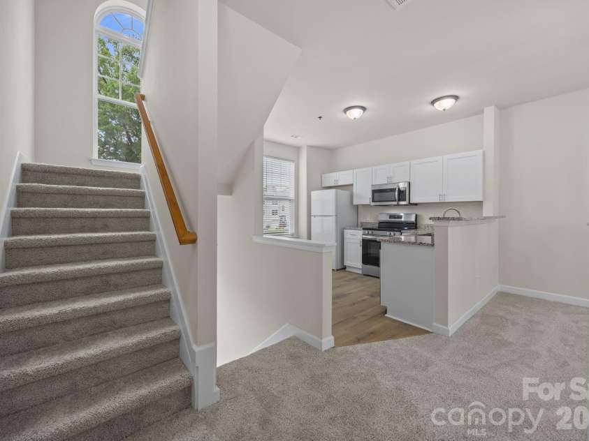 2750 Avalon Loop Road, Charlotte, NC 28269.  MLS# CAR4376282, YatesRealty ID 18660. Stairs to the 2 bedrooms upstairs.
