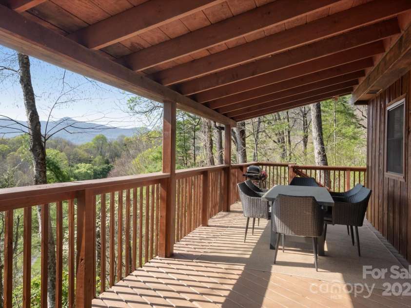 573 Countryside Drive, Waynesville, NC 28785.  MLS# CAR4244460, YatesRealty ID 18661. Large Deck with Outdoor Grilling Kitchen + Dining Furniture