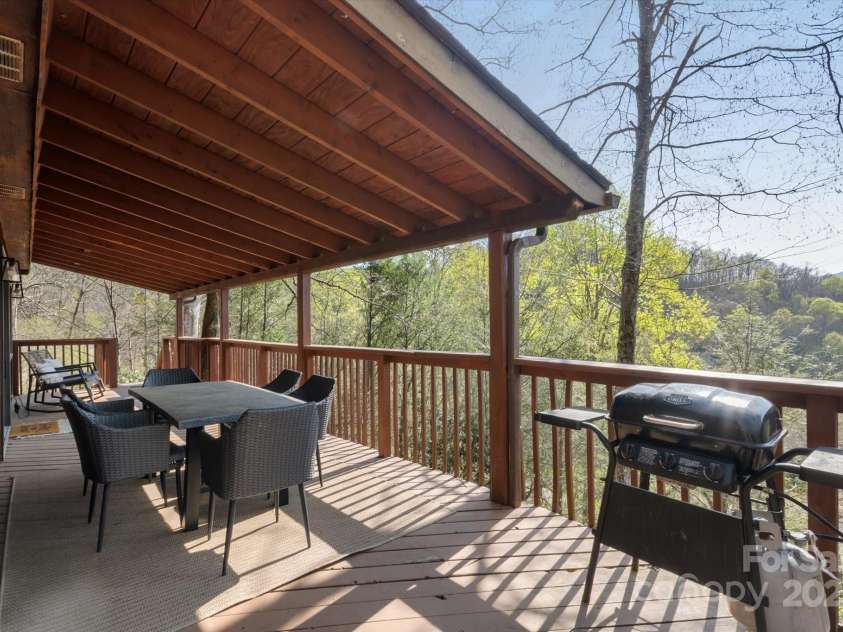 573 Countryside Drive, Waynesville, NC 28785.  MLS# CAR4244460, YatesRealty ID 18661. Large Deck with Outdoor Grilling Kitchen + Dining Furniture