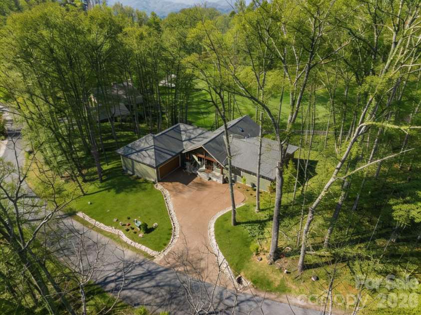 296 Austin Mountain Drive, Burnsville, NC 28714.  MLS# CAR4360900, YatesRealty ID 18662. Grass and trees are virtually edited
