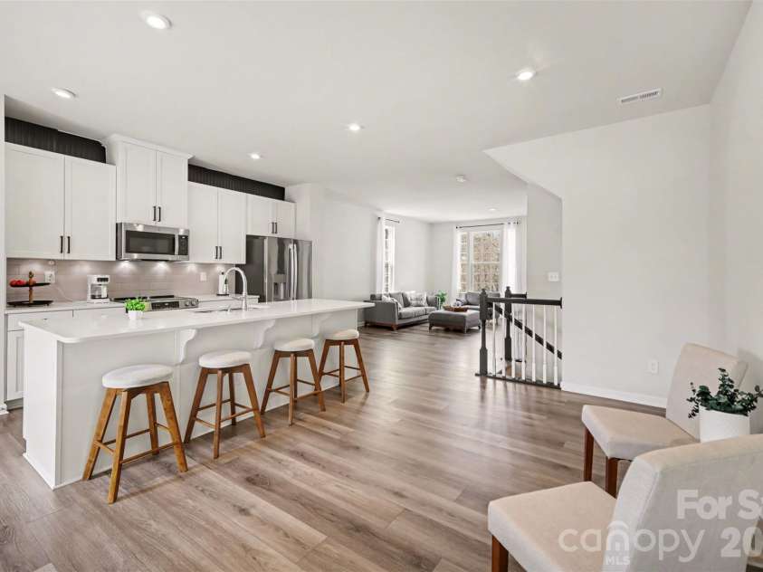 1211 May Apple Drive, Matthews, NC 28104.  MLS# CAR4349780, YatesRealty ID 18695. Bright open-concept kitchen featuring a large center island with seating.