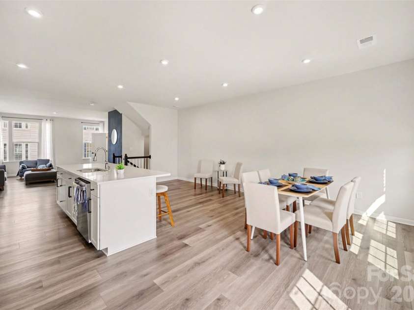 1211 May Apple Drive, Matthews, NC 28104.  MLS# CAR4349780, YatesRealty ID 18695. Bright open-concept, large kitchen island seamless flow into the dining area.