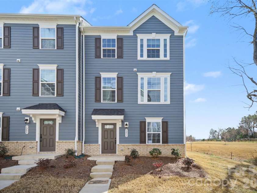 1211 May Apple Drive, Matthews, NC 28104.  MLS# CAR4349780, YatesRealty ID 18695. Charming end-unit townhome with partial front brick accent