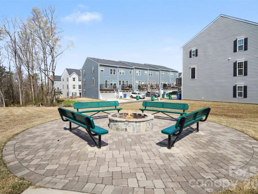 1211 May Apple Drive, Matthews, NC 28104.  MLS# CAR4349780, YatesRealty ID 18695. Community gathering area featuring a circular stone fire pit with benches