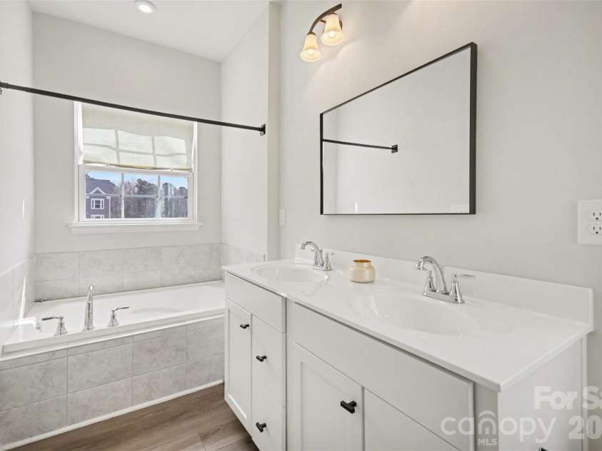 1211 May Apple Drive, Matthews, NC 28104.  MLS# CAR4349780, YatesRealty ID 18695. Primary bathroom soaking tub, and large window providing natural light
