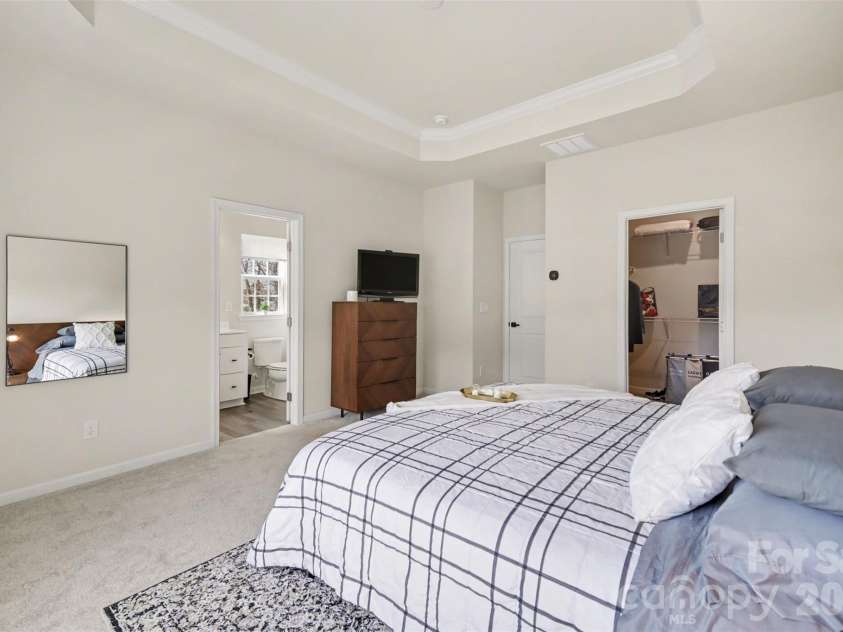 1211 May Apple Drive, Matthews, NC 28104.  MLS# CAR4349780, YatesRealty ID 18695. Primary bedroom convenient access to the ensuite bath & walk-in closet