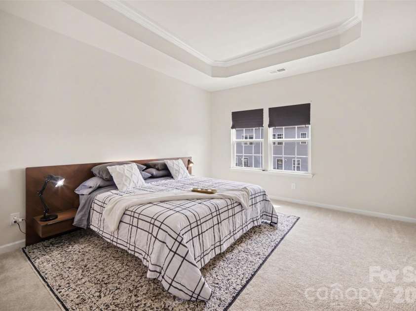 1211 May Apple Drive, Matthews, NC 28104.  MLS# CAR4349780, YatesRealty ID 18695. Spacious elegant primary bedroom with tray ceiling