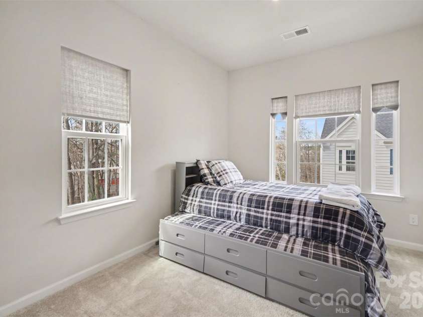 1211 May Apple Drive, Matthews, NC 28104.  MLS# CAR4349780, YatesRealty ID 18695. Spacious secondary bedroom with multiple windows and walk-in closet