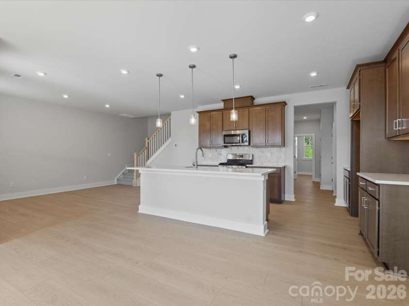 323 Ardmore Drive, Belmont, NC 28012.  MLS# CAR4378227, YatesRealty ID 18709. Chef-inspired kitchen with rich brown cabinets