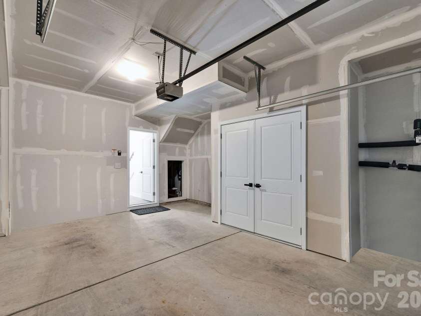 336 Twinflower Lane, Charlotte, NC 28205.  MLS# CAR4367102, YatesRealty ID 18739. Garage features added under-stair storage, offering convenient and functional extra space.