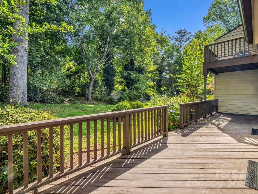 8 Hunting Country Trail, Tryon, NC 28782.  MLS# CAR4244551, YatesRealty ID 18739. Main level deck facing equestrian trails