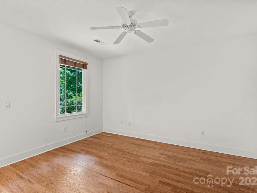 50 Mandolin Drive, Black Mountain, NC 28711.  MLS# CAR4264408, YatesRealty ID 18743. Here is another view of one of the lower level bedrooms that has an access door to a private patio that is shared by the two lower level bedrooms, which each have their own separate access door to the patio.