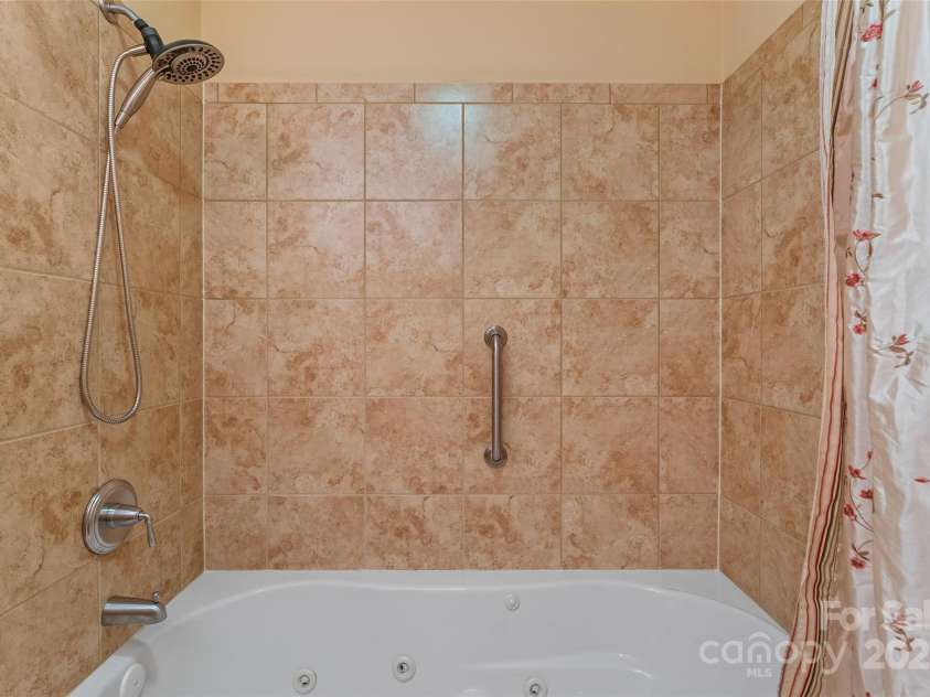 50 Mandolin Drive, Black Mountain, NC 28711.  MLS# CAR4264408, YatesRealty ID 18743. I can't say enough about the lower level jet tub and shower combo. It is beautiful. It's tiled and provides a wonderful place for guests to feel at home. When it's time for them to go home they just might not want t