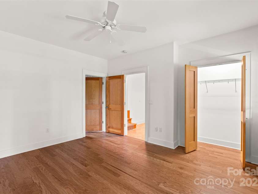 50 Mandolin Drive, Black Mountain, NC 28711.  MLS# CAR4264408, YatesRealty ID 18743. The generous bedroom in the daylight basement is one of two bedrooms that are quite roomy. It features a nice closet, plus it has a door that leads to the large utility room, which is great for storing seasonal stuf