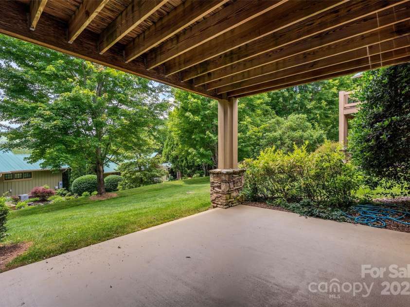 50 Mandolin Drive, Black Mountain, NC 28711.  MLS# CAR4264408, YatesRealty ID 18743. The Lower level patio is private and overlooks the green park-like common area. It can be accessed from either of the two daylight basement bedrooms.