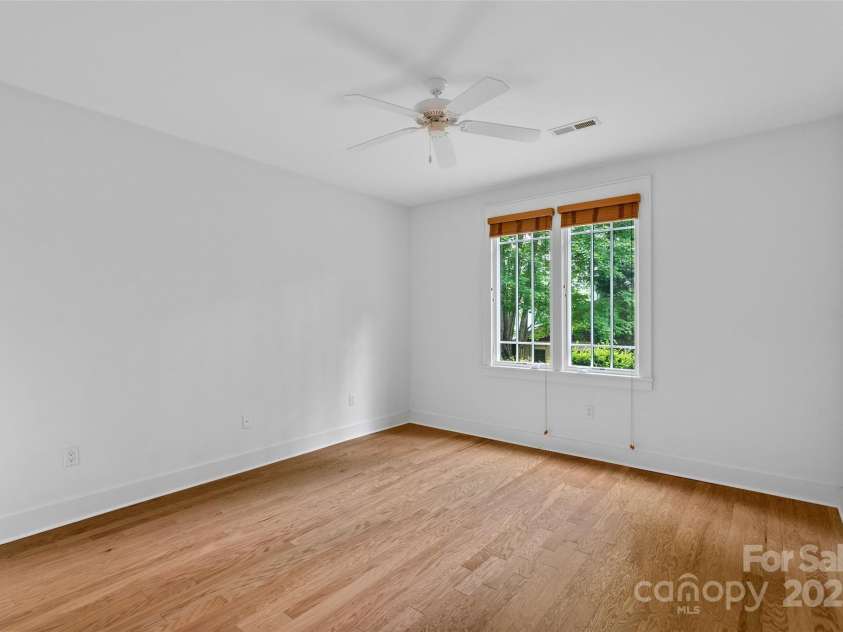 50 Mandolin Drive, Black Mountain, NC 28711.  MLS# CAR4264408, YatesRealty ID 18743. This bedroom on the second level also has its own door leading to the patio shared with the other lower level bedroom.   It has a spacious, cedar-lined, walk-in closet!