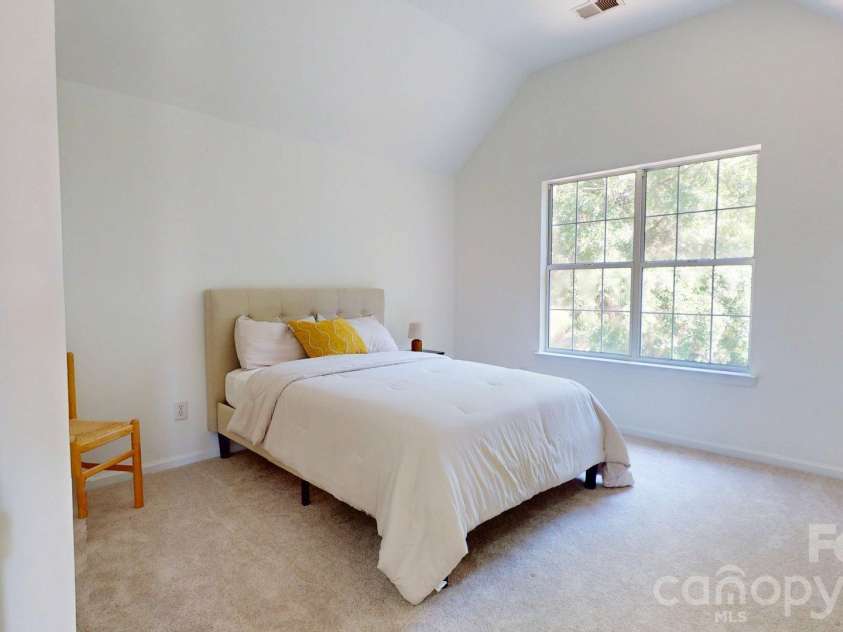6501 Outer Bridge Lane, Charlotte, NC 28270.  MLS# CAR4377519, YatesRealty ID 18747. One of two upstairs secondary bedrooms. This one with partially vaulted ceiling.