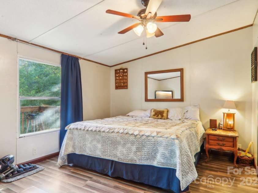 138 Buddy Lane, Chimney Rock, NC 28720.  MLS# CAR4326250, YatesRealty ID 1875. Generously sized owners suite bedroom