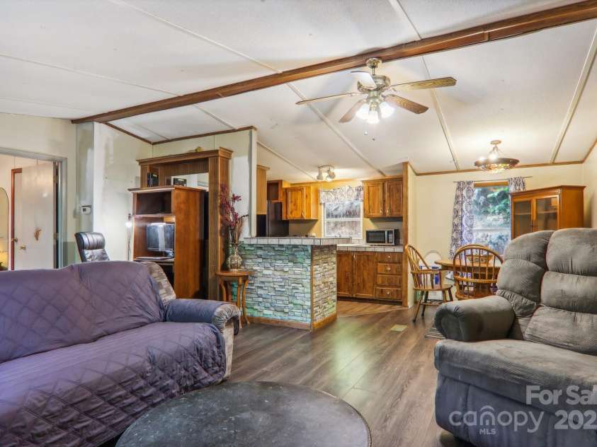 138 Buddy Lane, Chimney Rock, NC 28720.  MLS# CAR4326250, YatesRealty ID 1875. Living room into dining area