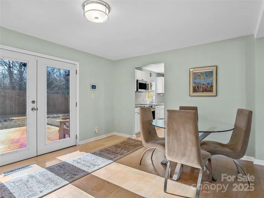 435 Thermal View Drive, Tryon, NC 28782.  MLS# CAR4334421, YatesRealty ID 1876. Dining area with French doors leading to the back deck.