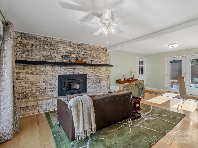 435 Thermal View Drive, Tryon, NC 28782.  MLS# CAR4334421, YatesRealty ID 1876. Family room with woodstove insert.