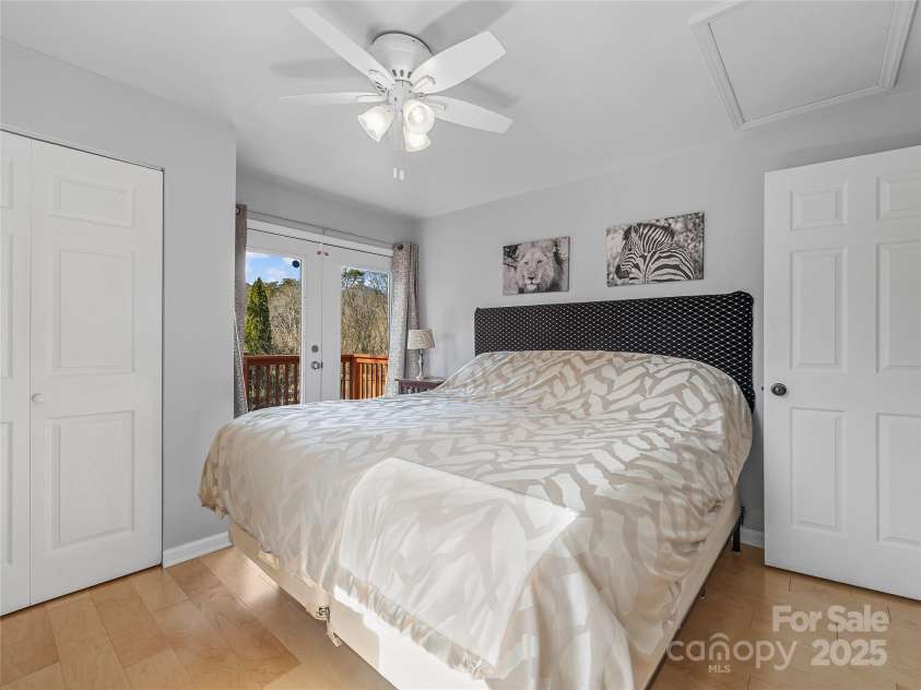 435 Thermal View Drive, Tryon, NC 28782.  MLS# CAR4334421, YatesRealty ID 1876. Primary bedroom with French doors leading to the third deck