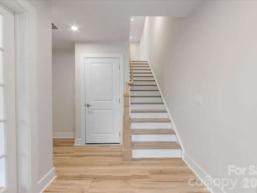 6008 Pivot Court, Charlotte, NC 28205.  MLS# CAR4396115, YatesRealty ID 18768. Oak box stairs with open rails