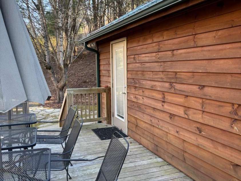 324 Marble Mine Road, Bakersville, NC 28705.  MLS# CAR4237907, YatesRealty ID 1877. Main house side deck. Come out through the French doors and listen to the water flowing down the creek