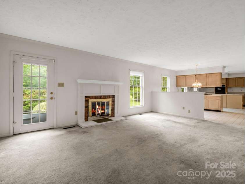 2000 Golf Course Road, Columbus, NC 28722.  MLS# CAR4268144, YatesRealty ID 18782. Open living space from den to kitchen.