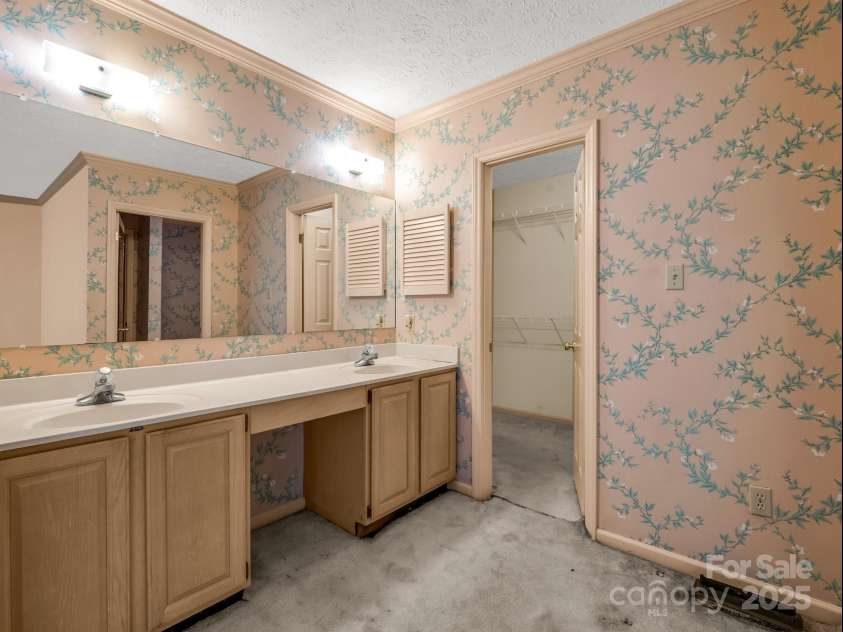 2000 Golf Course Road, Columbus, NC 28722.  MLS# CAR4268144, YatesRealty ID 18782. Primary bedroom sink area with walk in closet.