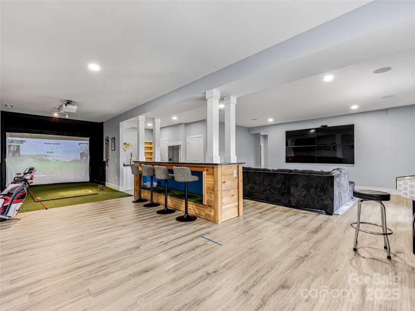 16 Pisgah Ridge Trail, Mills River, NC 28759.  MLS# CAR4257871, YatesRealty ID 18784. Lower Level Entertainment Space with Bar and Golf Simulator.