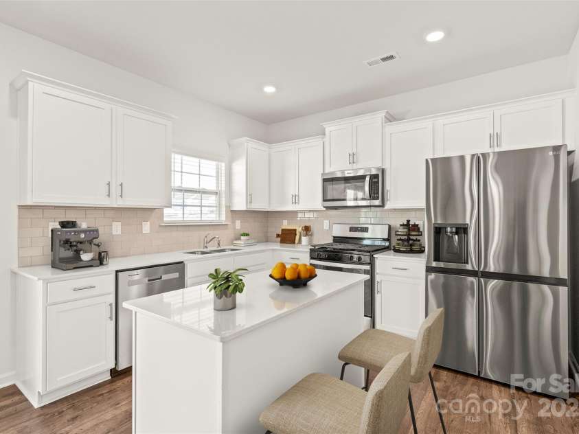 7324 Teague Drive, Gastonia, NC 28056.  MLS# CAR4217797, YatesRealty ID 18793. Spacious kitchen with island and stainless appliances including gas stove