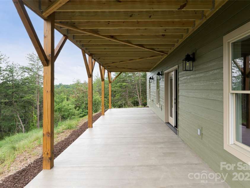 181 Flint Morgan Road, Mars Hill, NC 28754.  MLS# CAR4288459, YatesRealty ID 1880. Covered patio off Family Room