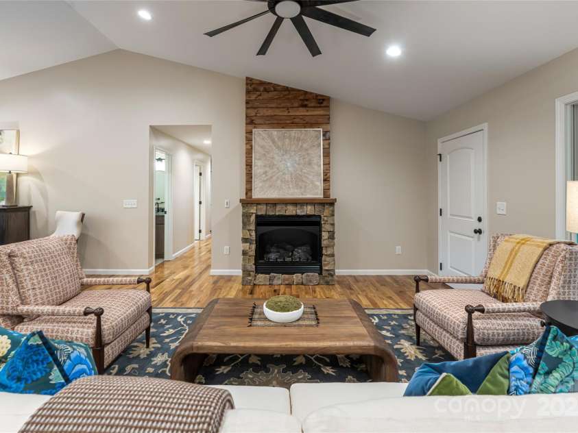 181 Flint Morgan Road, Mars Hill, NC 28754.  MLS# CAR4288459, YatesRealty ID 1880. Living Room centers around a statement fireplace
