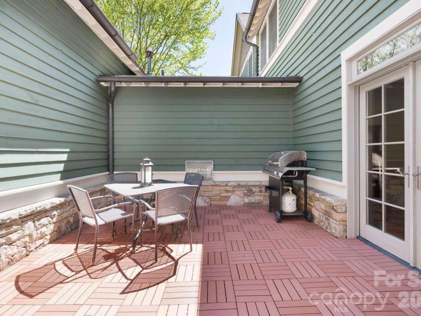 4 Fitzgerald Road, Black Mountain, NC 28711.  MLS# CAR4371041, YatesRealty ID 18801. Private courtyard off the main living area with new non-slip tiles on the ground. 