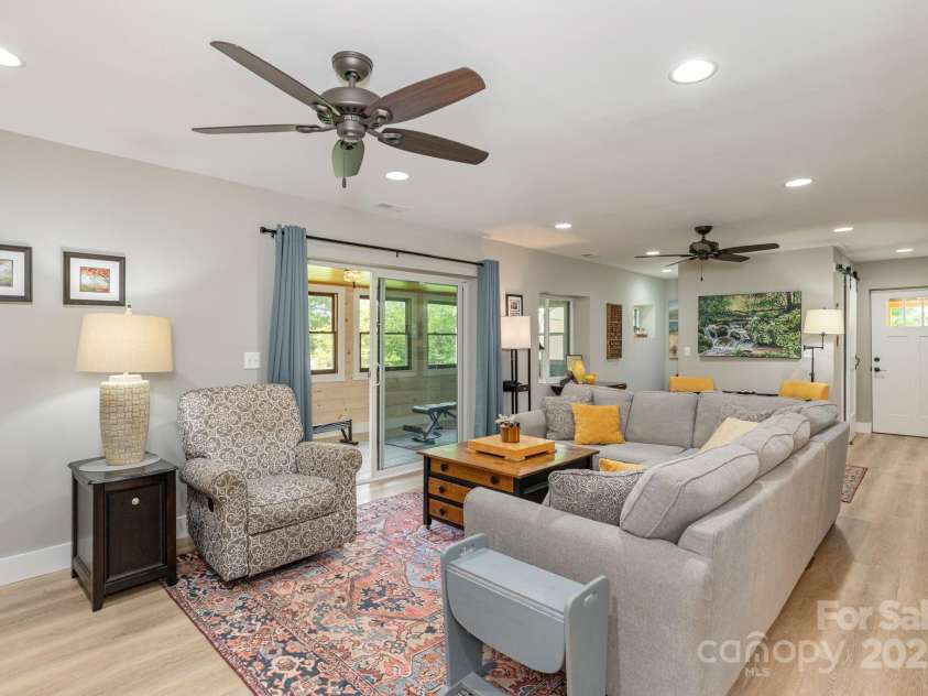 4329 Island Ford Road, Brevard, NC 28712.  MLS# CAR4252076, YatesRealty ID 18801. Living Room leading to Sunroom