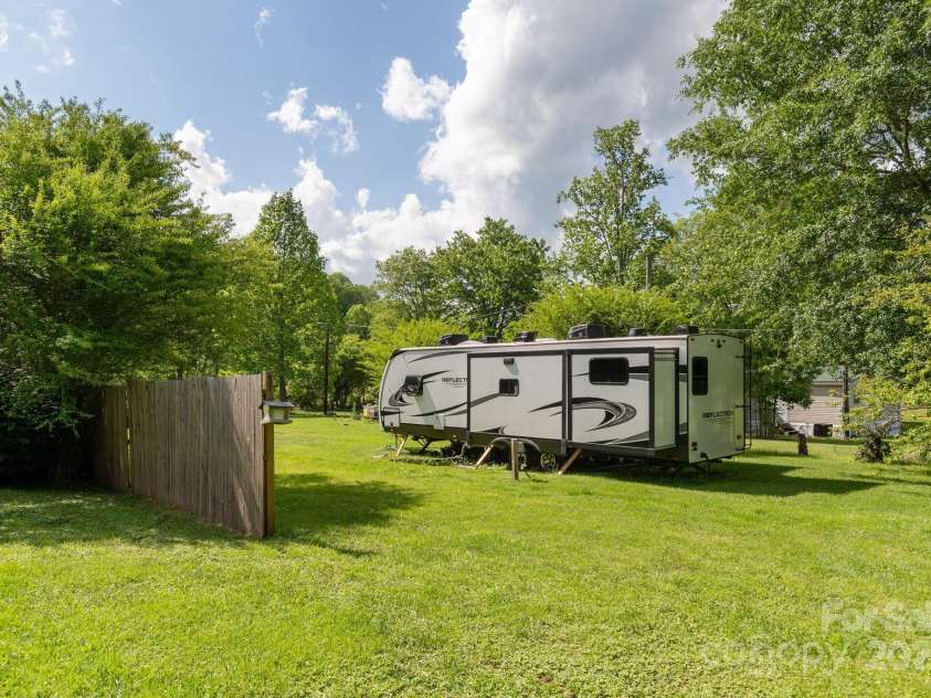 4329 Island Ford Road, Brevard, NC 28712.  MLS# CAR4252076, YatesRealty ID 18801. Privacy Fence separates 53 Mossberg Lane which is the second lot.  RV does not belong to owner of home and does not come with the sale!