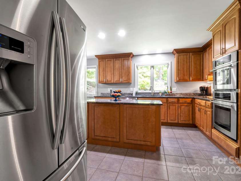 97 Ballantree Drive, Asheville, NC 28803.  MLS# CAR4231911, YatesRealty ID 18818. Half- Bathroom near kitchen walk in pantry