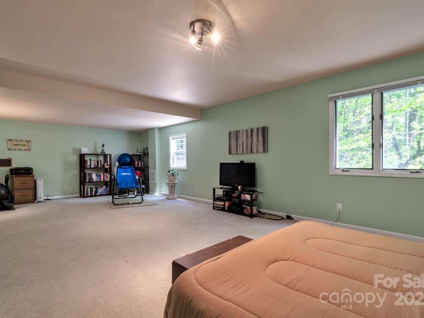97 Ballantree Drive, Asheville, NC 28803.  MLS# CAR4231911, YatesRealty ID 18818. Large lower-level bedroom with adjoining flex area ideal for a private lounge, office, or workout space.