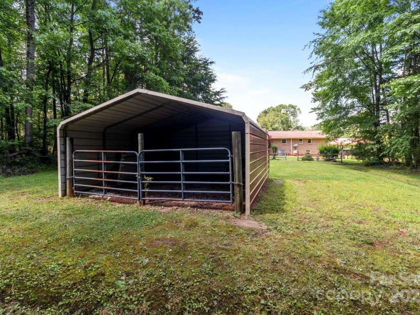 885 Roy Cline Road, Rockwell, NC 28138.  MLS# CAR4268618, YatesRealty ID 18819. Metal building with double gate