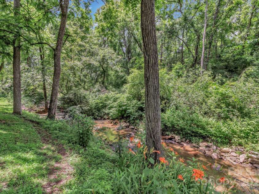 222 New Stock Road, Weaverville, NC 28787.  MLS# CAR4266697, YatesRealty ID 18833. Beautiful stream in the back of the property!