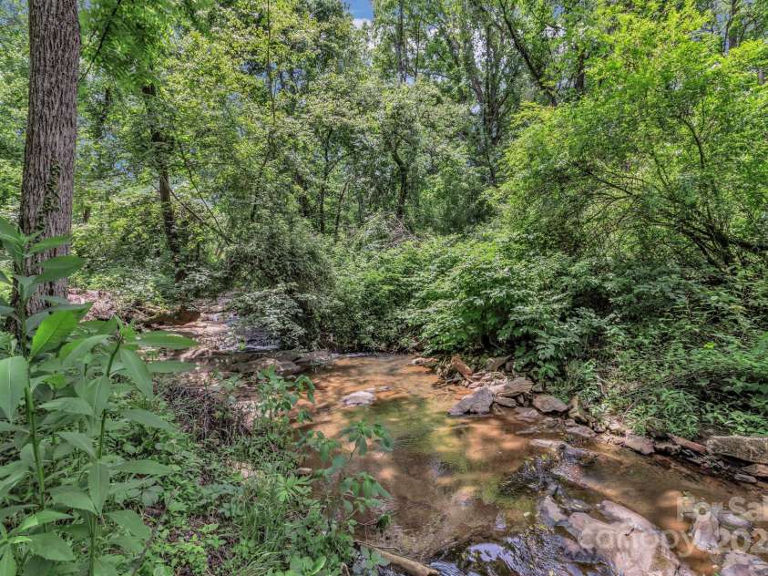 222 New Stock Road, Weaverville, NC 28787.  MLS# CAR4266697, YatesRealty ID 18833. Beautiful stream in the back of the property!