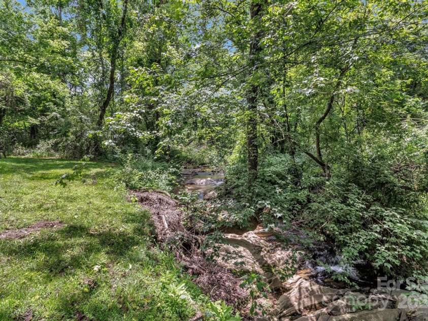 222 New Stock Road, Weaverville, NC 28787.  MLS# CAR4266697, YatesRealty ID 18833. Beautiful stream in the back of the property!