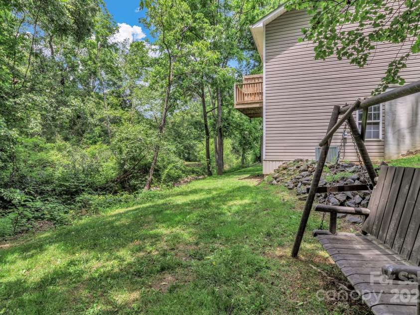 222 New Stock Road, Weaverville, NC 28787.  MLS# CAR4266697, YatesRealty ID 18833. Side yard