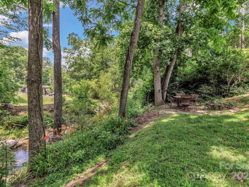 222 New Stock Road, Weaverville, NC 28787.  MLS# CAR4266697, YatesRealty ID 18833. Side yard