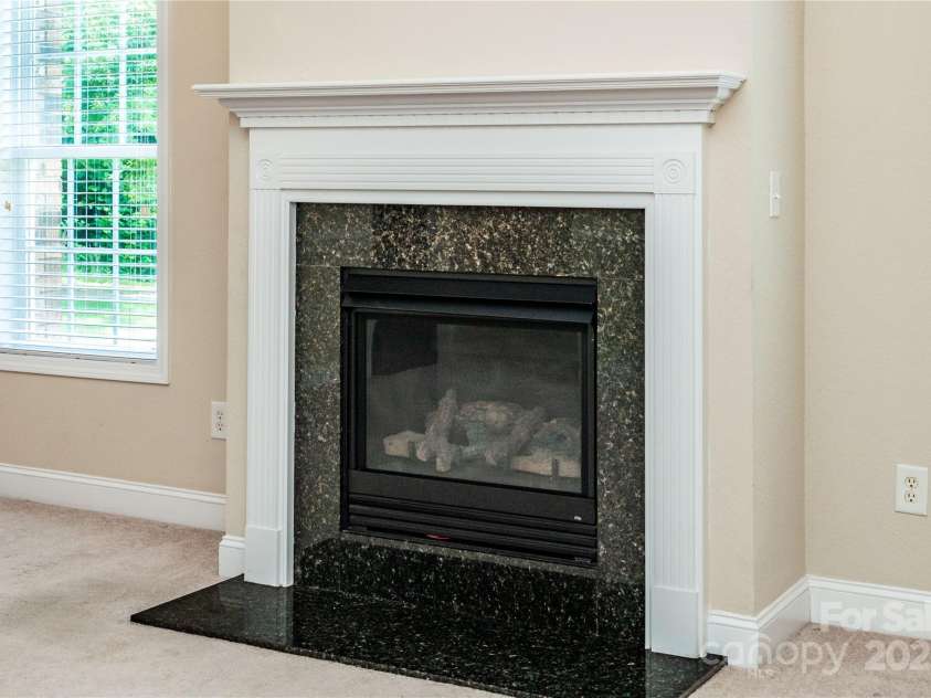 141 Aberdeen Drive, Troutman, NC 28166.  MLS# CAR4269630, YatesRealty ID 18836. Cozy gas fireplace - low maintenance!
