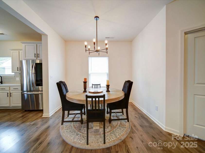 5121 Arbordale Way, Mount Holly, NC 28120.  MLS# CAR4269641, YatesRealty ID 18852. Dining Area is Open to The Kitchen and Features a Custom Light Fixture