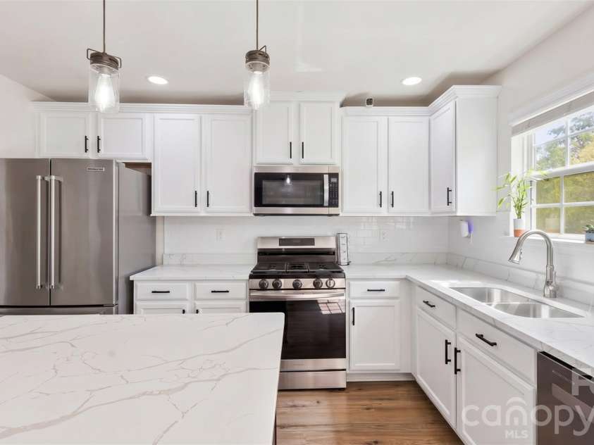 4715 Mcclure Road, Charlotte, NC 28216.  MLS# CAR4403073, YatesRealty ID 18855. Visualization of white cabinet & refrigerator upgrade