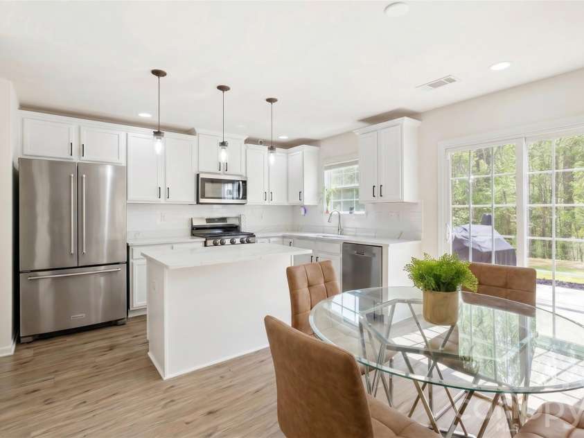 4715 Mcclure Road, Charlotte, NC 28216.  MLS# CAR4403073, YatesRealty ID 18855. Visualization of white cabinet & refrigerator upgrade