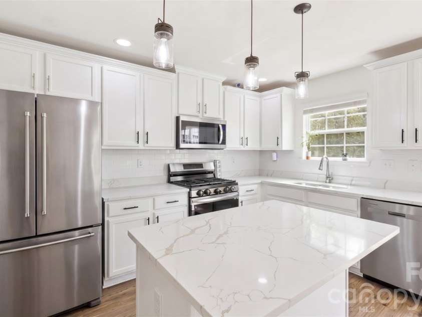 4715 Mcclure Road, Charlotte, NC 28216.  MLS# CAR4403073, YatesRealty ID 18855. Visualization of white cabinet & refrigerator upgrade